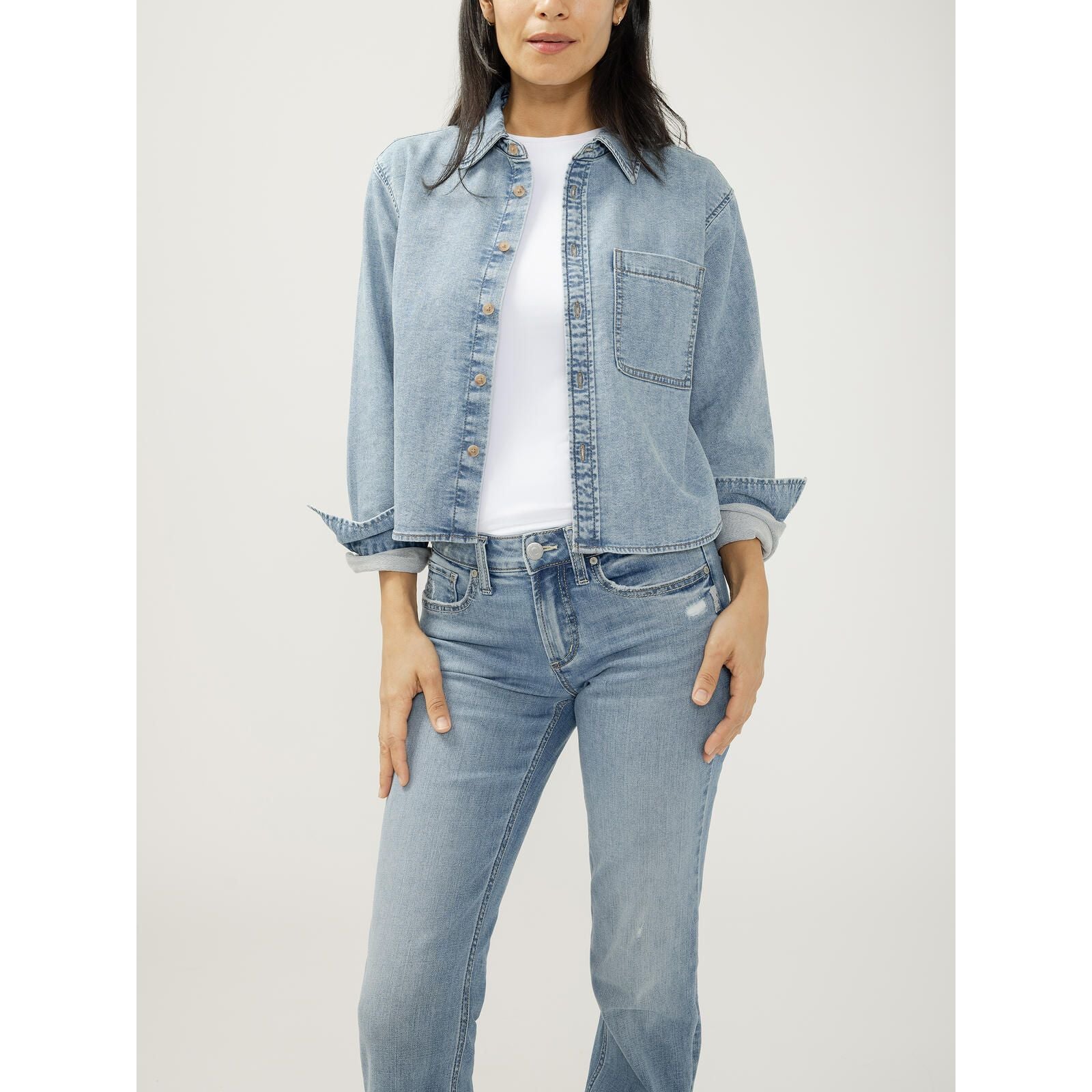 Women's silver denim button front knit flex shirt in a relaxed cropped fit with rolled sleeves and chest pocket.