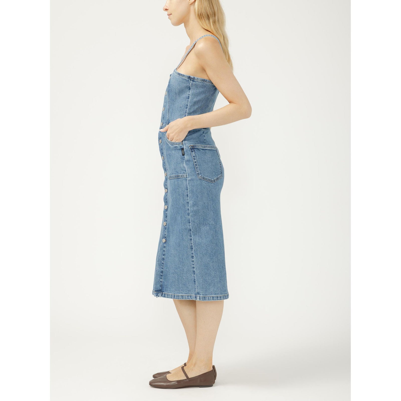Denim midi dress with silver button-front closure, adjustable spaghetti straps, fitted silhouette.