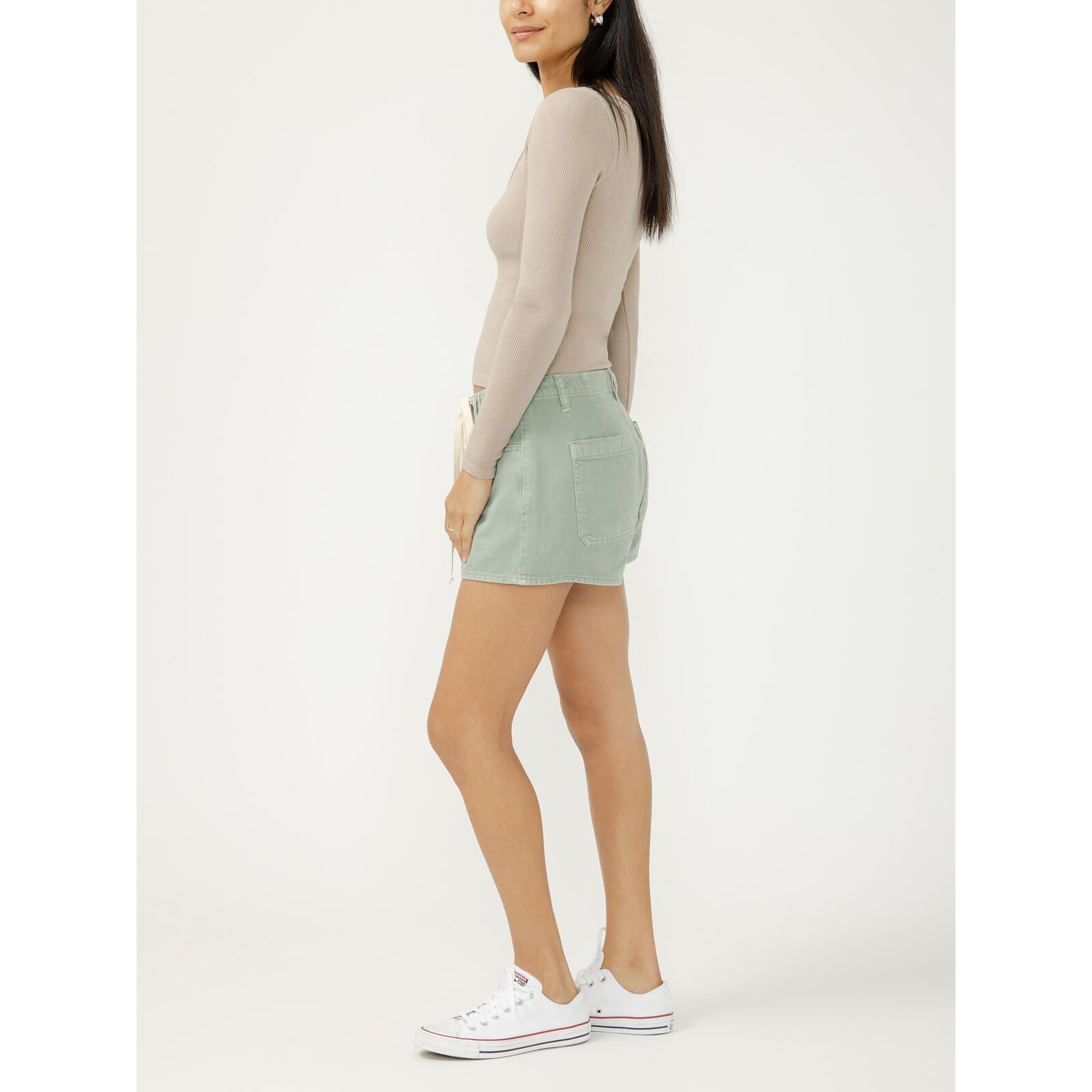 Model wearing Silver Drawstring Beach Short in light green denim with a drawstring waistband and beige rib-knit top.