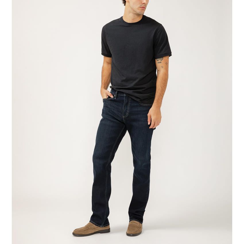 Stylish man wearing Silver Grayson Straight in Radio Denim, featuring a comfortable fit and sleek straight leg design.