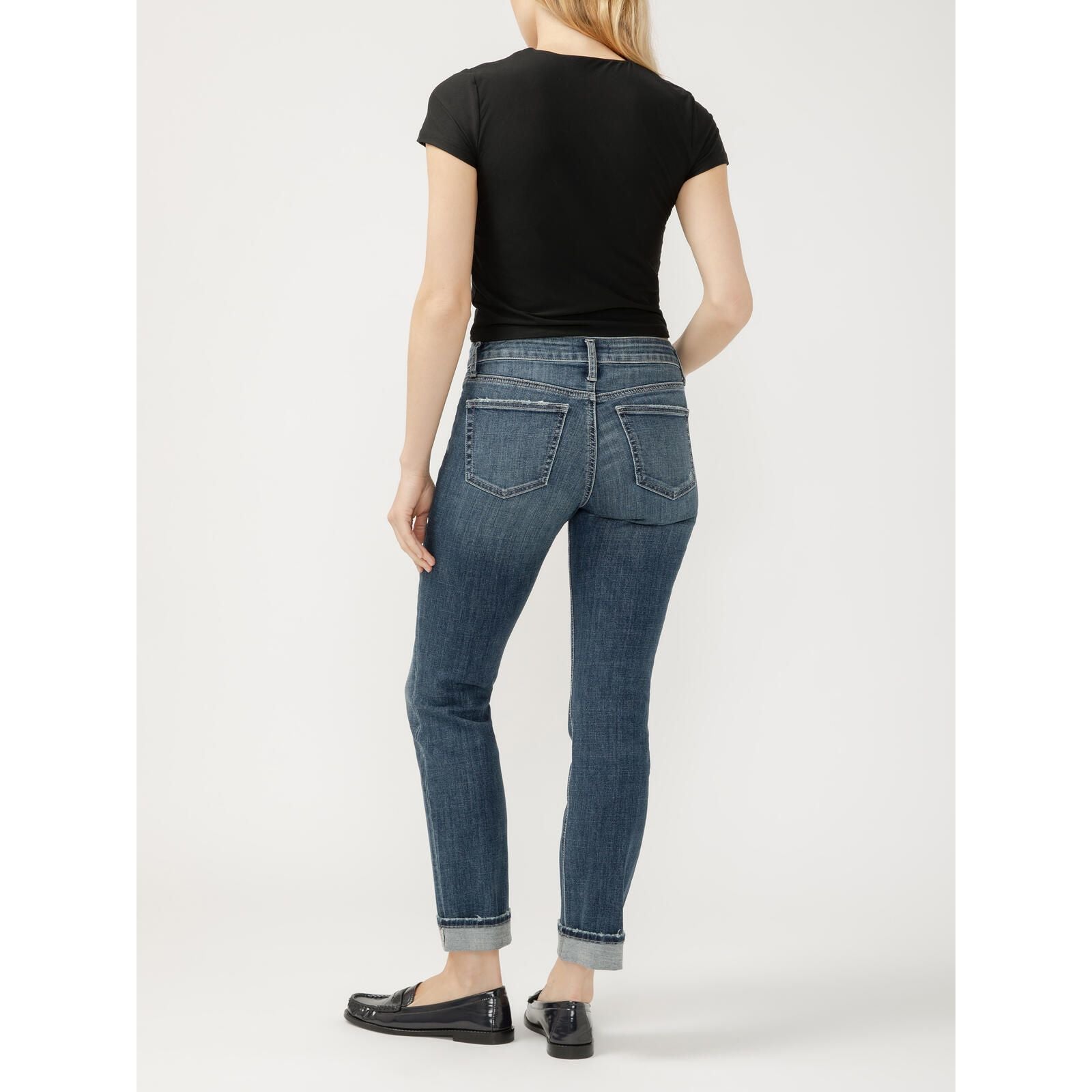 Back view of a model wearing Silver Suki Straight Leg in Isles Denim jeans with rolled cuffs and a mid-rise waistband.