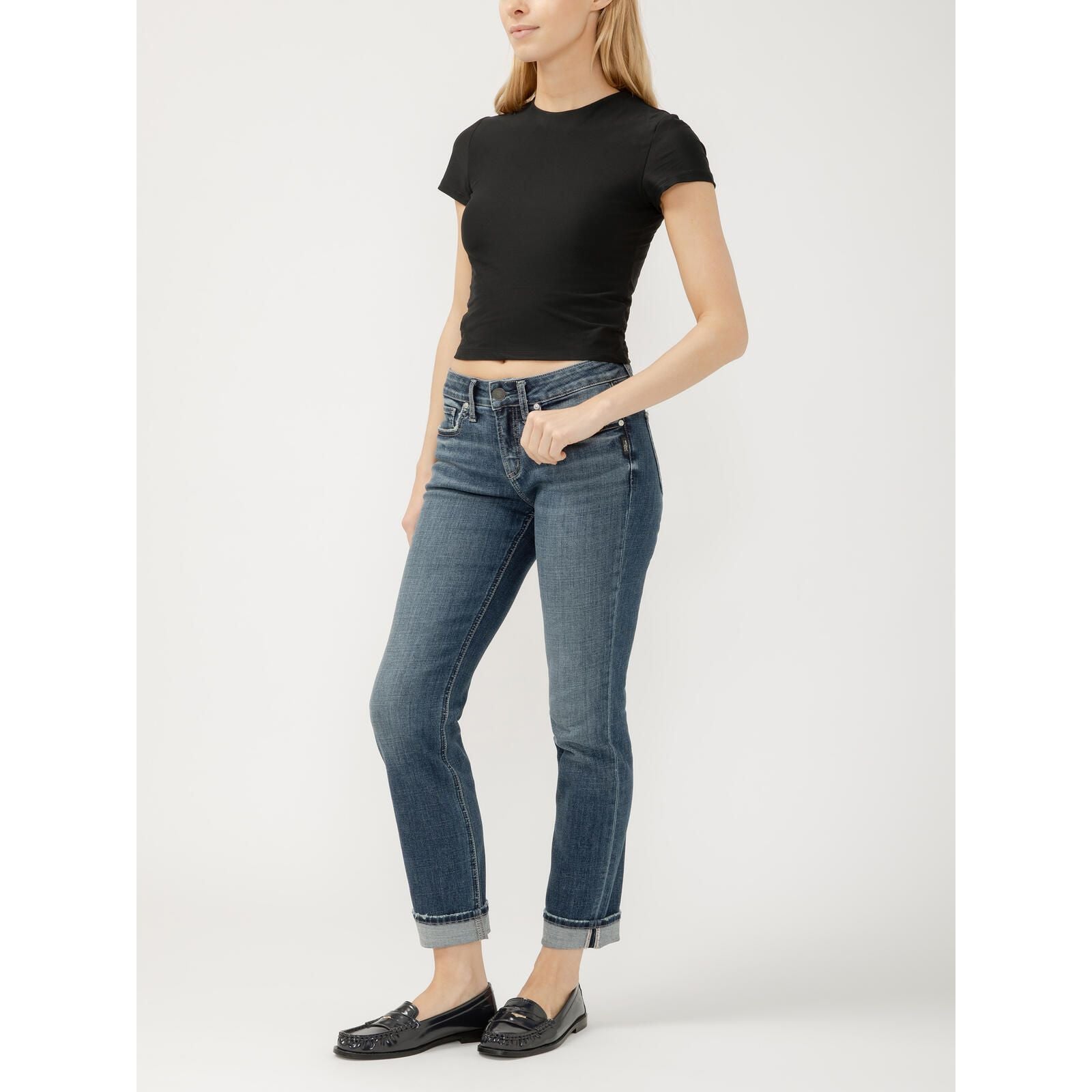 Model wearing Silver Suki Straight Leg jeans in Isles Denim with a black cropped tee and rolled cuffs.