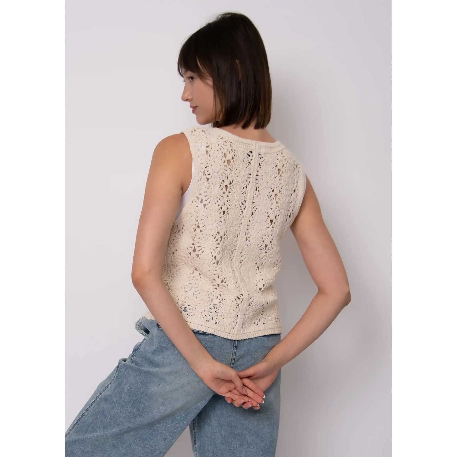 Sloane Knit Cardigan: cream sleeveless crochet knit with floral pattern, single button closure, relaxed fit.