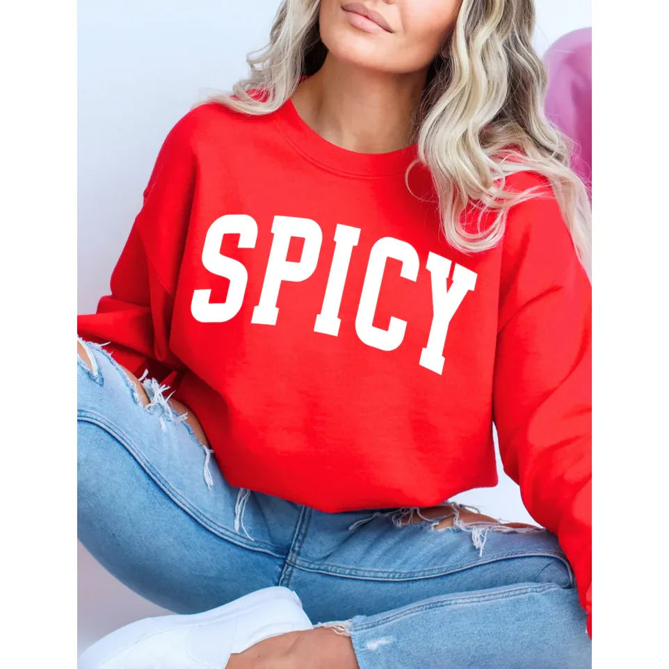 Spicy Classic Crew red crewneck sweatshirt with bold SPICY lettering, paired with ripped jeans.