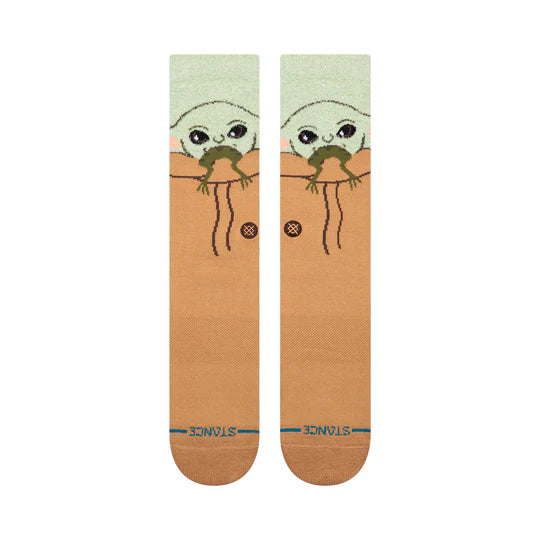 Stance Star Wars Grogu Hungry Crew Socks with Grogu peeking over an orange-brown backdrop.