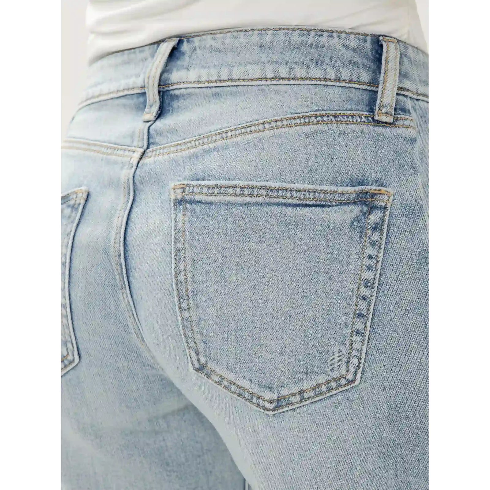 Light-wash back pocket of Silver Suki Wide Leg Cropped jeans in West End, with belt loop and topstitching.