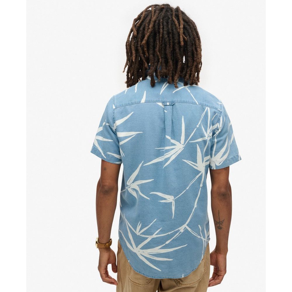 Back view of a blue Vintage Loom short-sleeve shirt with white loom pattern, worn with tan pants.