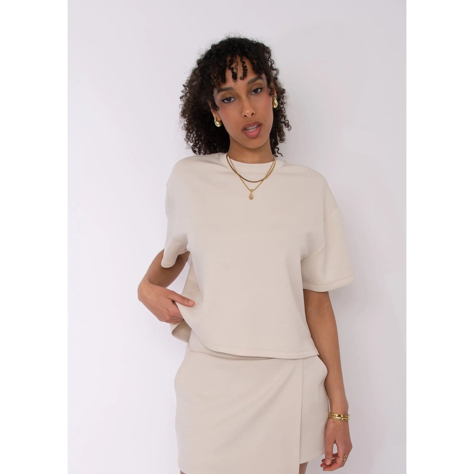 Tess Soft Knit Top in beige, boxy knit with short sleeves, model wearing size Small in a matching set.