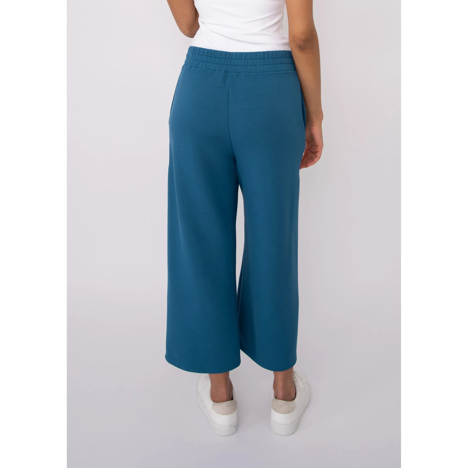 Victoria Soft Knit Cropped Pants in teal with a wide leg and elastic waistband, back view.