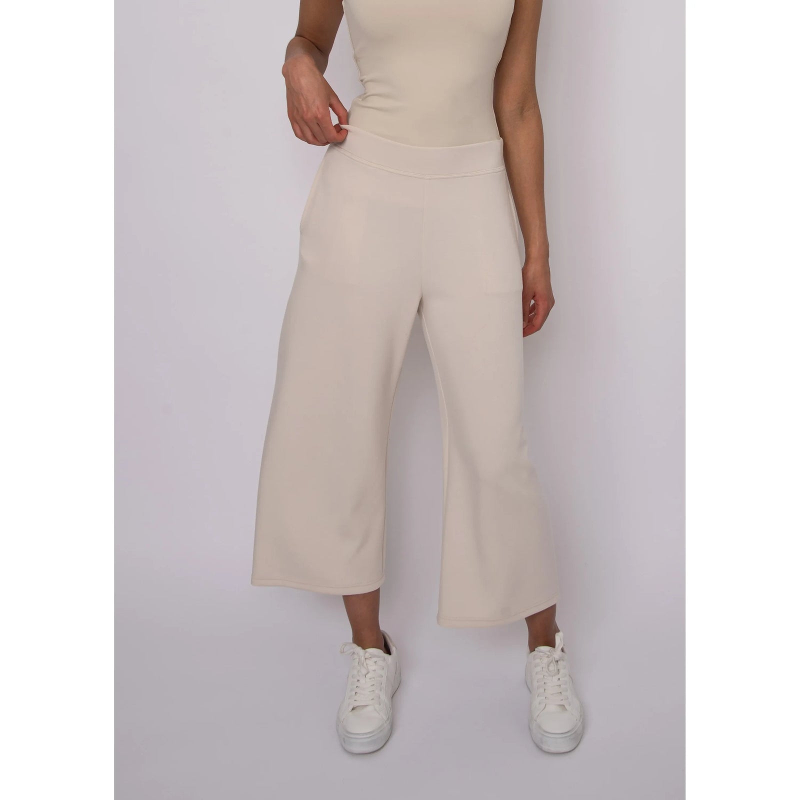 Victoria Soft Knit Cropped Pants in beige with a wide leg and pockets; model wears size Small.