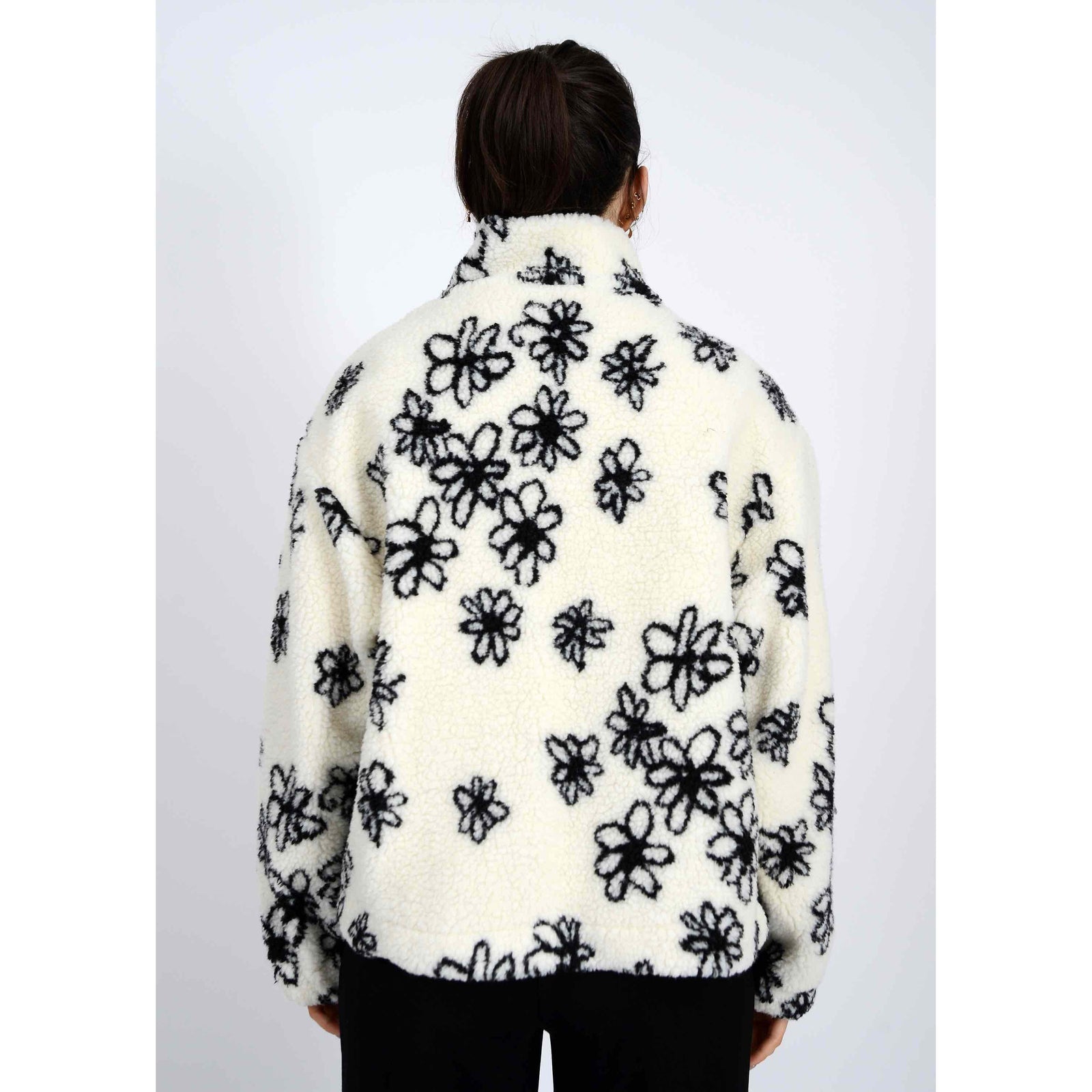 Whistler Sherpa Jacket: white sherpa fleece with black snowflake print, back view of a model.