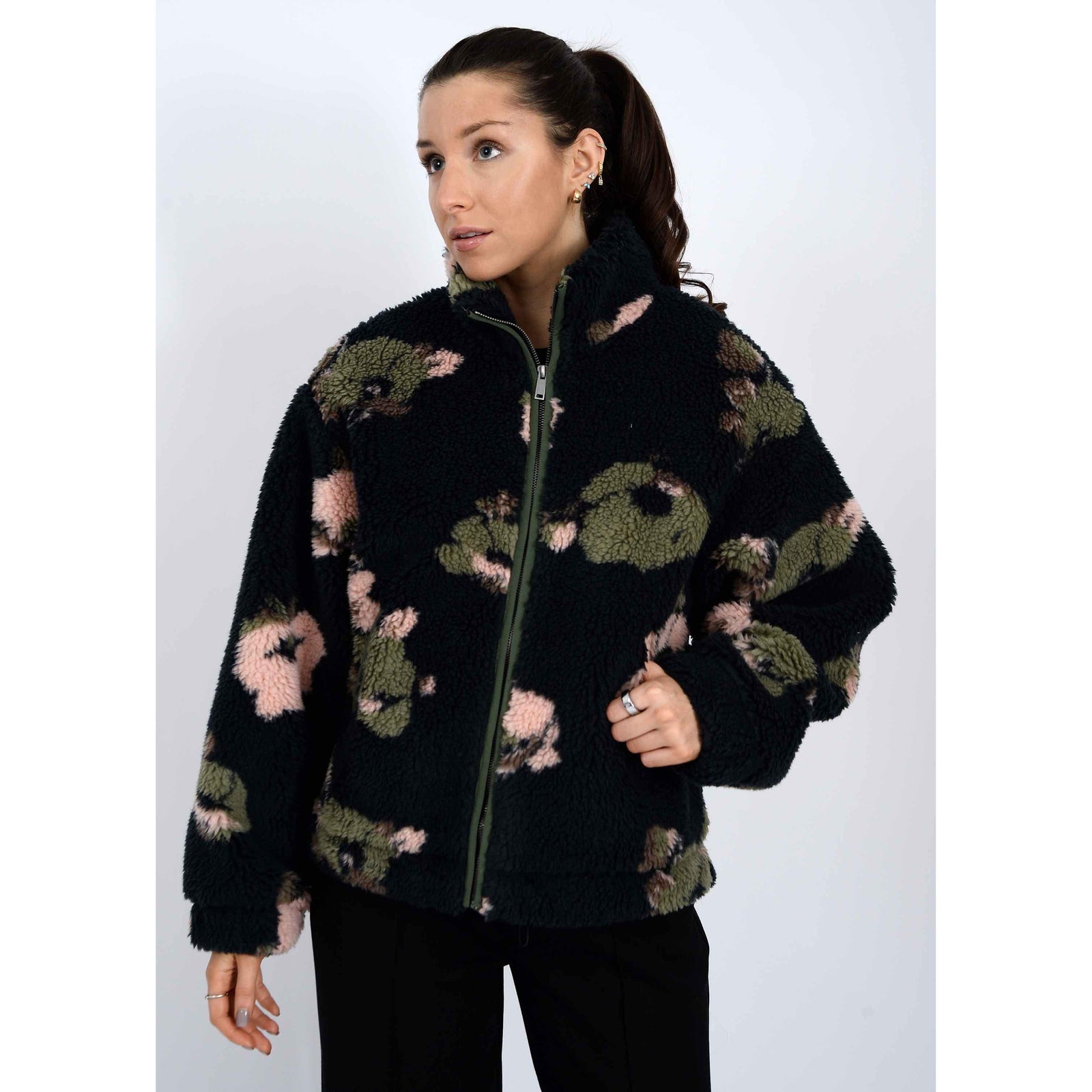 Whistler Sherpa Jacket worn by a model in a black camo fleece with zip closure and high mock collar.