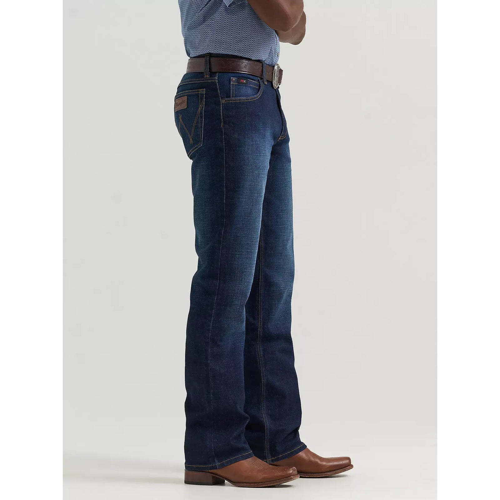Person wearing Wrangler 20X Active Flex Regular fit Twilight jeans with a brown belt and brown boots.