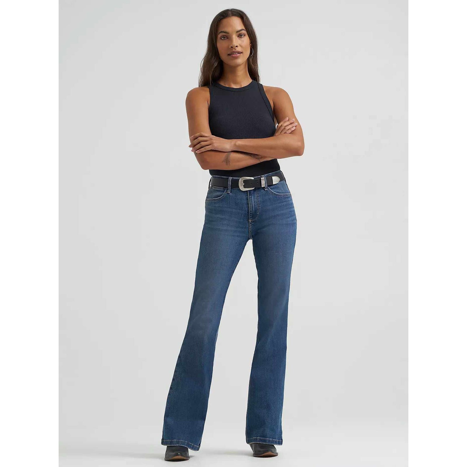 Wrangler Bespoke Flare in Lily: woman modeling high-rise flare jeans with contoured waistband and angled back pockets.