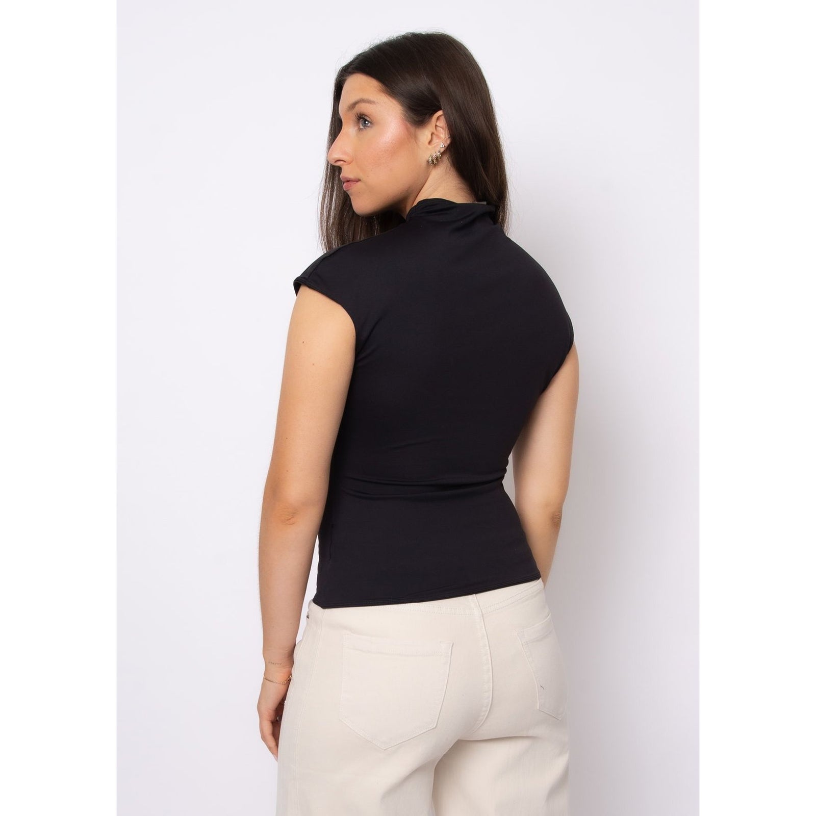 Back view of a model wearing Yvette Funnel Neck Draped Top in black, sleeveless with a refined neckline.