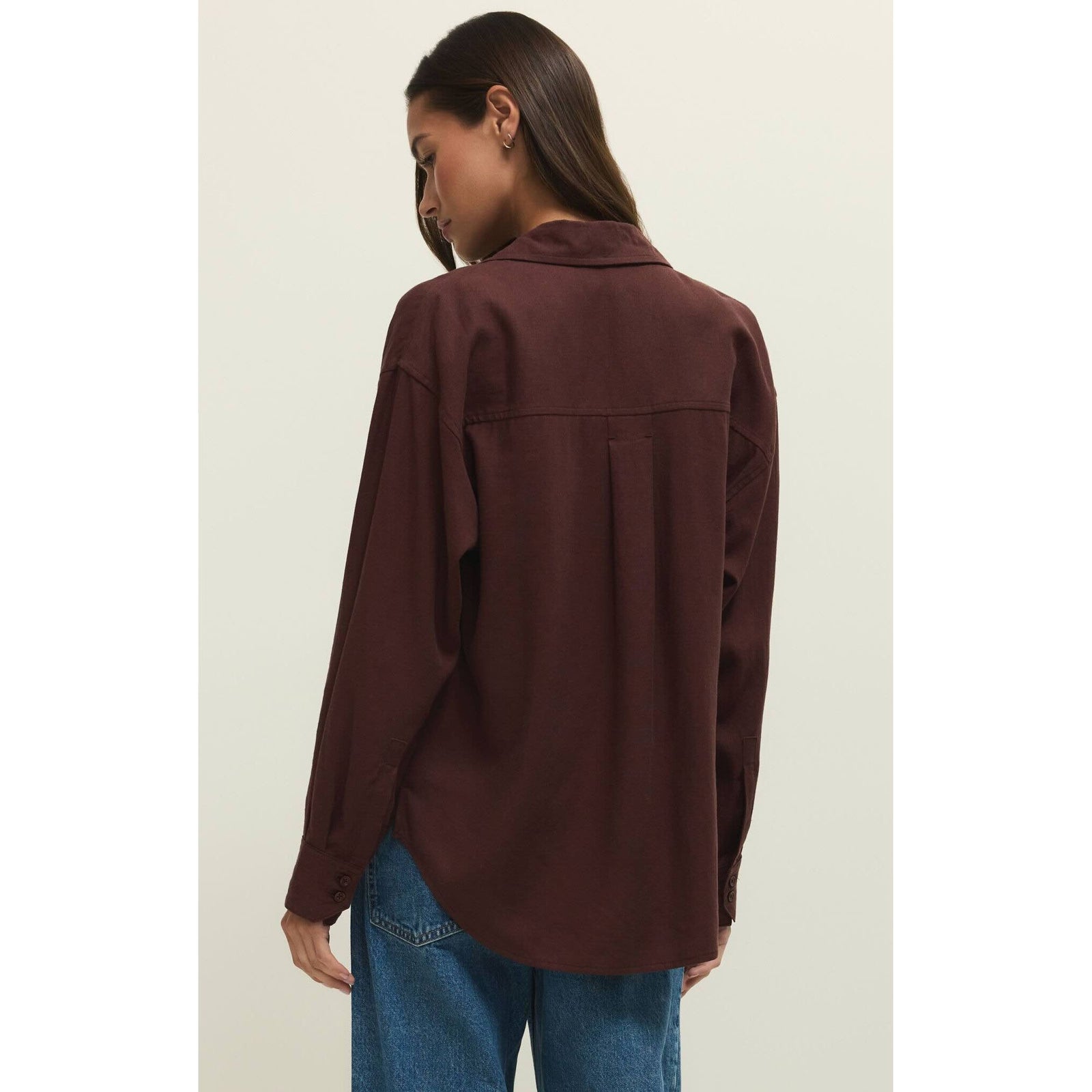 Back view of model wearing burgundy linen Z Supply Alfie Button Up Shirt with relaxed drape and classic collar.
