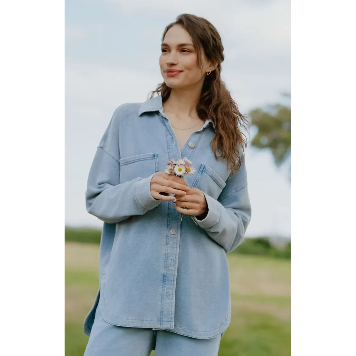 Z Supply All Day Knit Denim Jacket in light blue worn by a woman outdoors; soft knit denim with French Terry.