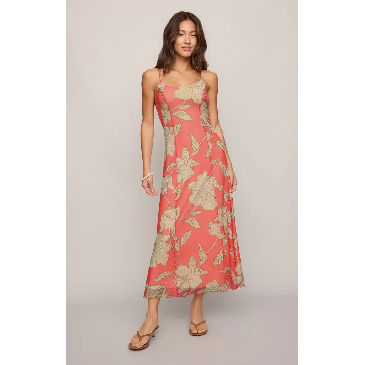 Model in coral tropical floral Charisma Bloom Midi Dress with adjustable straps and built-in shelf bra.