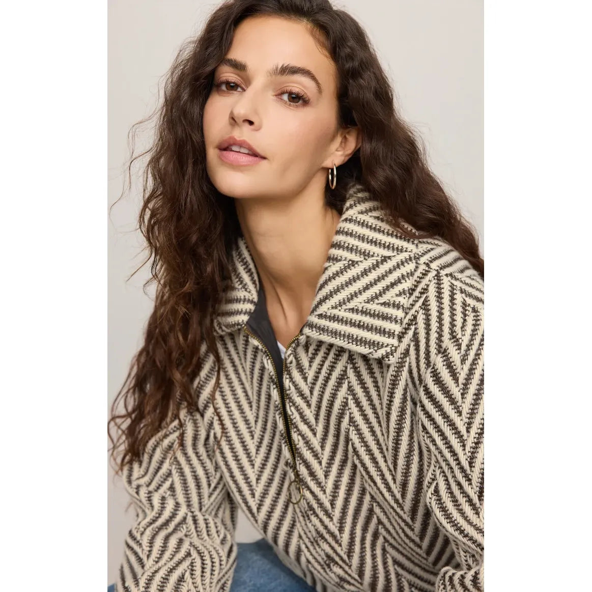 Vintage-inspired herringbone bubble jacket with antique brass zip closure, snap cuffs, and fully lined timeless character.
