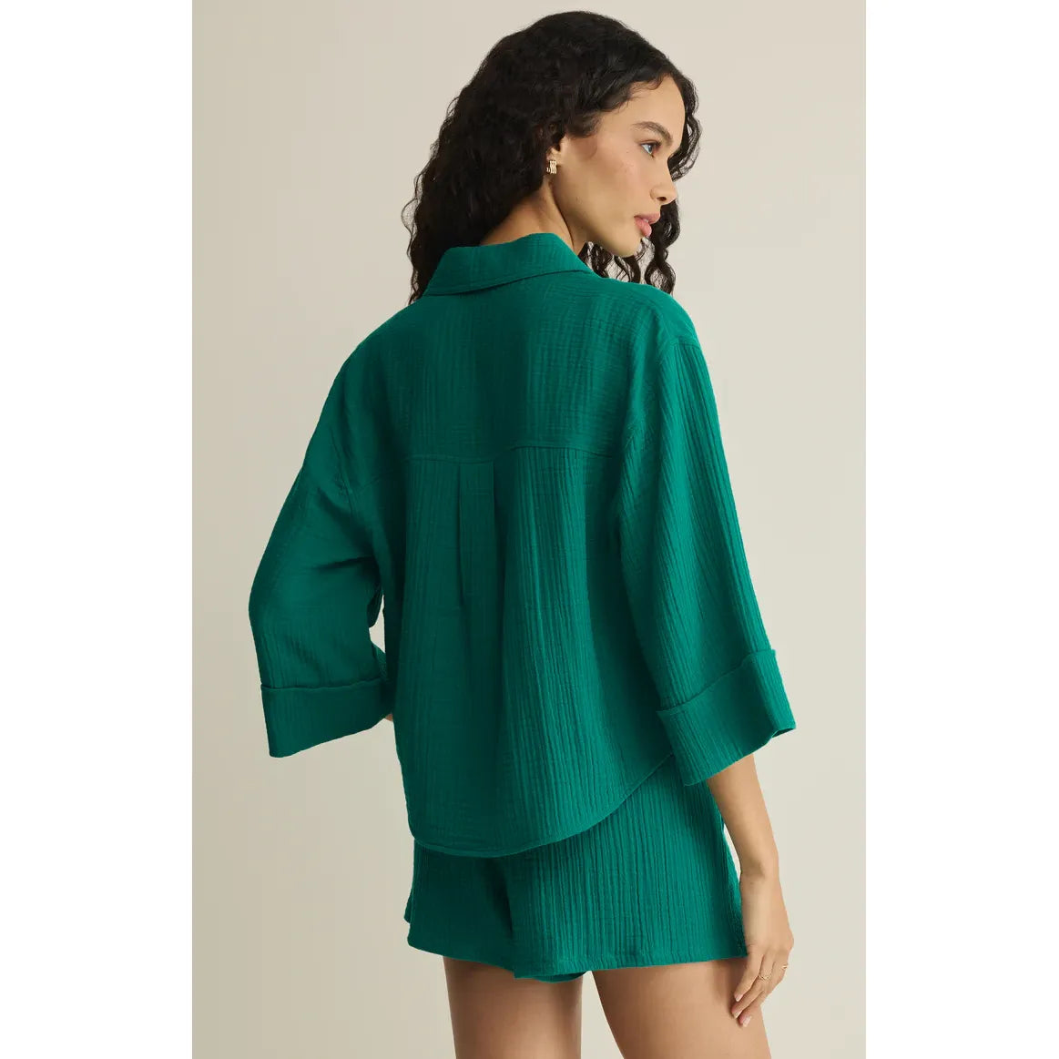 Z Supply Helena Shirt in teal with a relaxed silhouette, rolled cuffs, and back pleat detail.