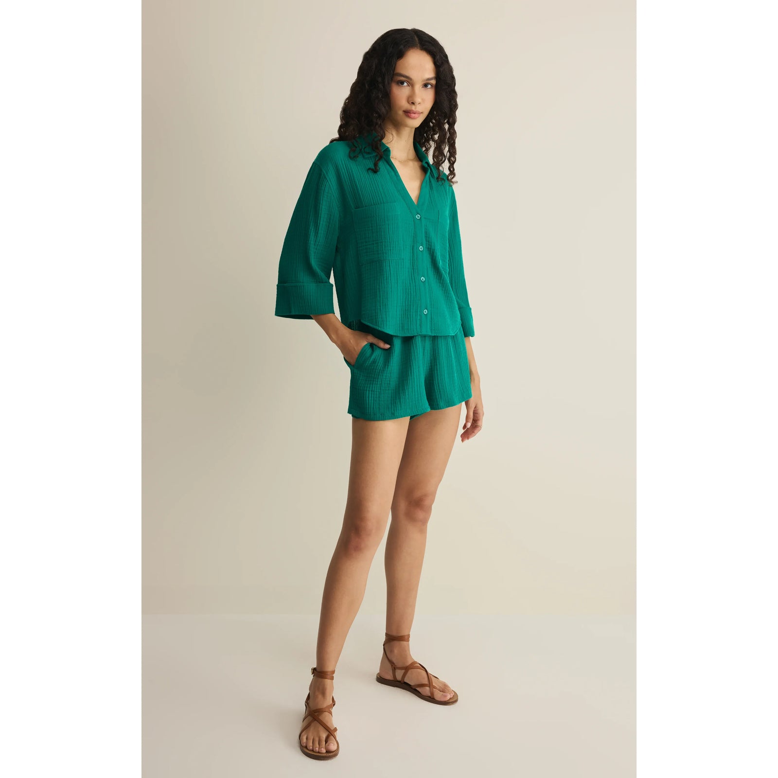 Model in teal Z Supply Helena Shirt paired with matching shorts, showcasing a relaxed, refined silhouette.