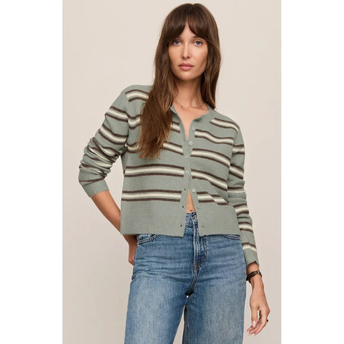Retro sage green and brown striped cardigan with button-front closure, styled with blue jeans for cozy, nostalgic comfort.
