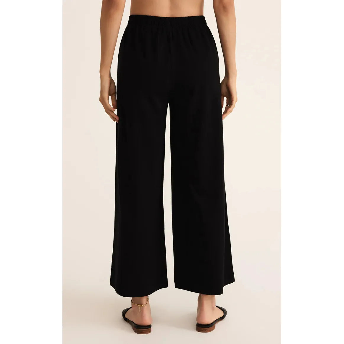 Back view of black Z Supply Scout Jersey Flare Pant with elastic high-rise waist and wide-leg fit.