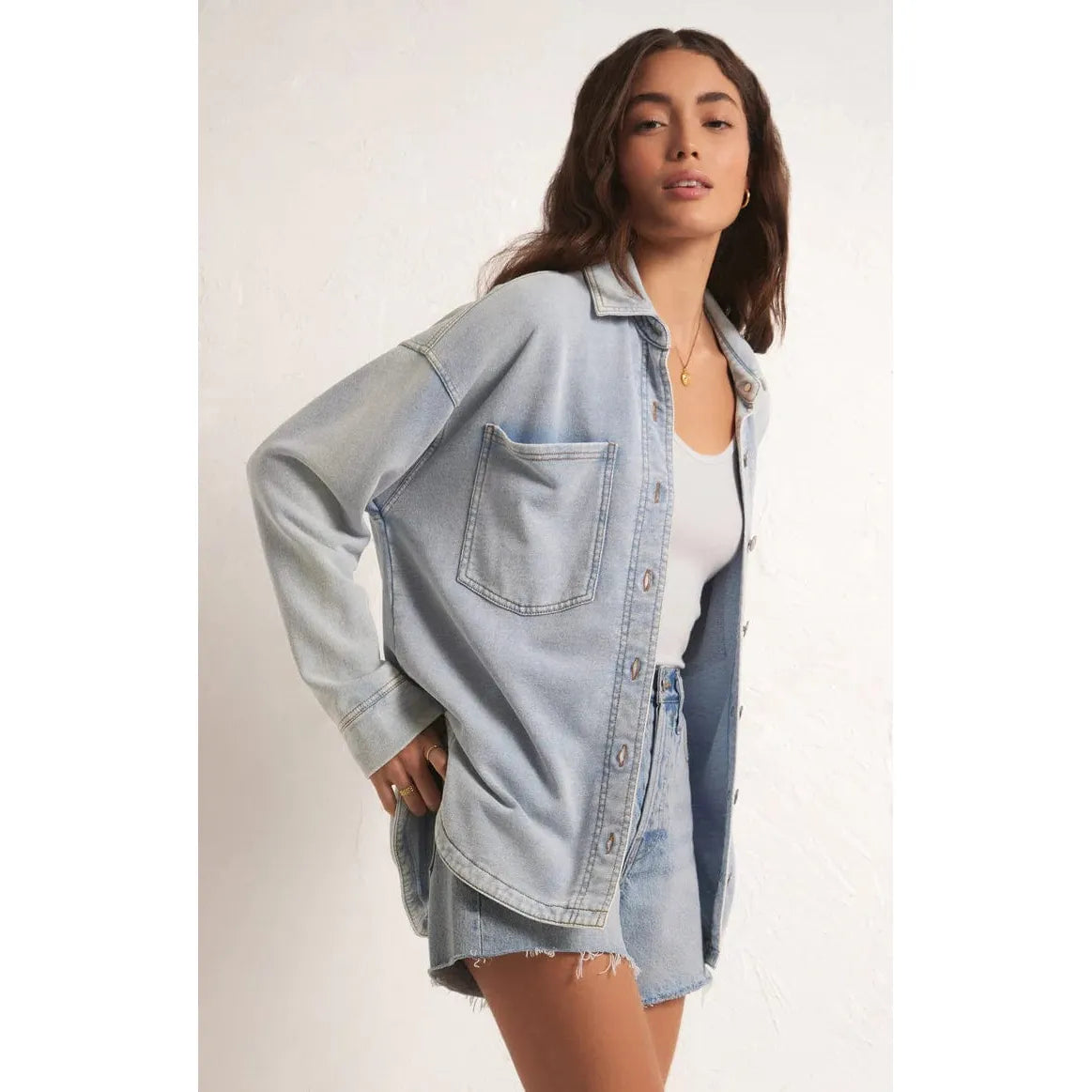 Stylish model wearing the Z Supply All Day Knit Denim Jacket, showcasing its soft French terry fabric and casual look.