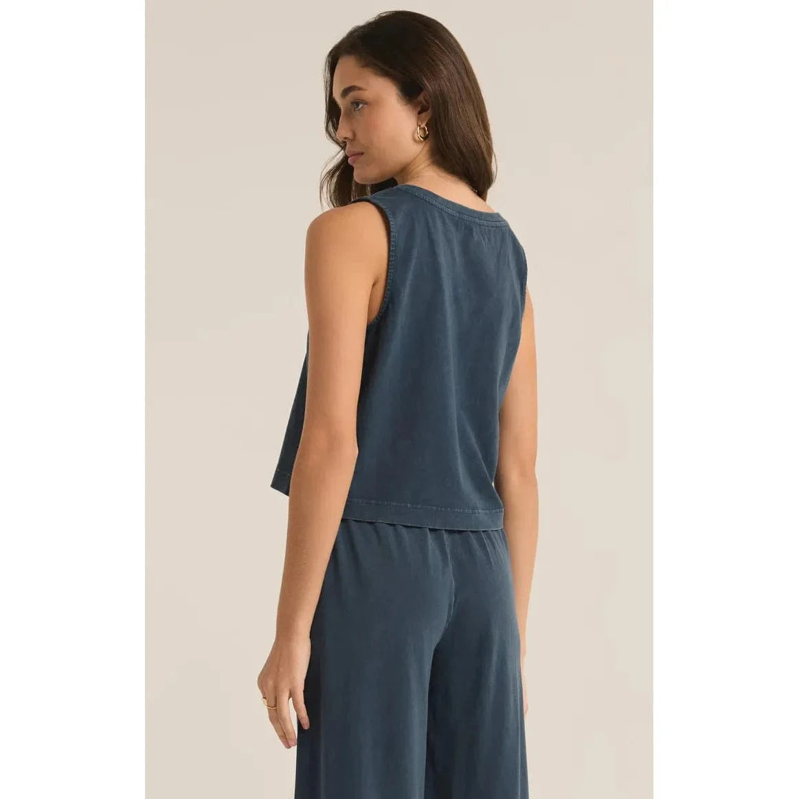 Stylish woman wearing the Z Supply Sloane V-Neck Tank - Sale, showcasing its relaxed fit and sleeveless design.