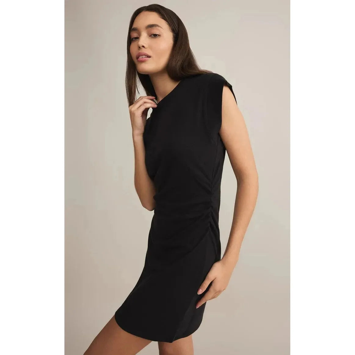 Stylish model wearing the Z Supply Camino Mini Dress, showcasing its flattering fit and cap sleeves in black.