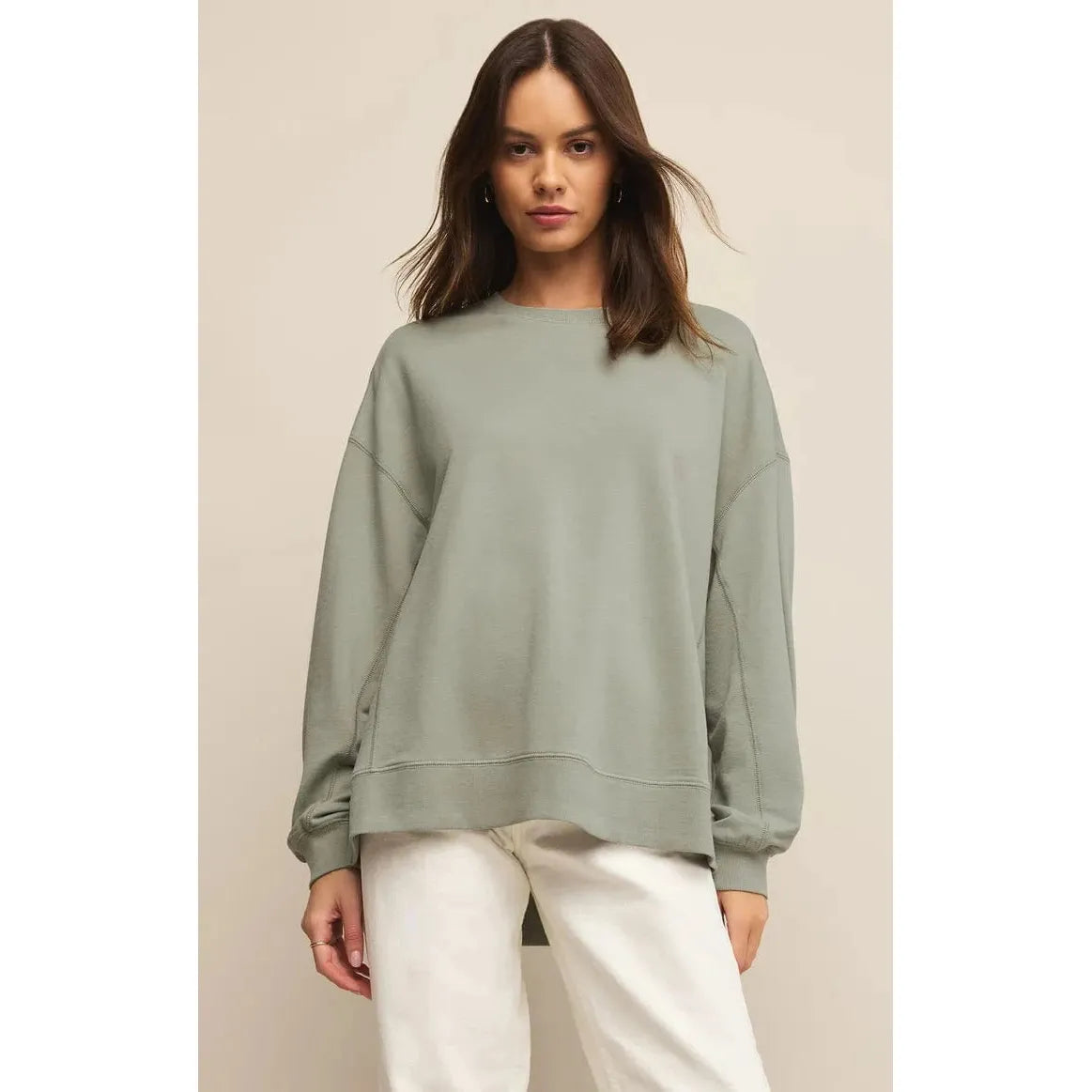 Stylish model wearing the Z Supply Modern Weekender in sage green, perfect for casual comfort and versatility.