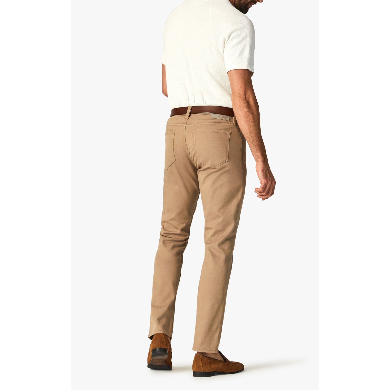 Back view of a man wearing 34 Heritage Courage Khaki Summer CoolMax pants in tan with a brown belt.