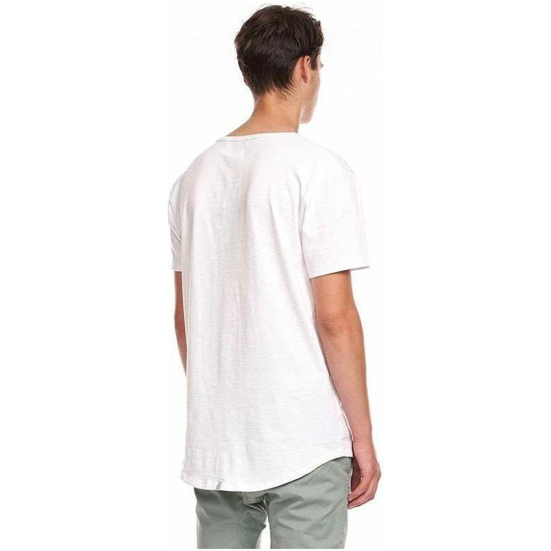 Kuwalla Scoop Tee in white, back view on a model with scooped hem and branded label.