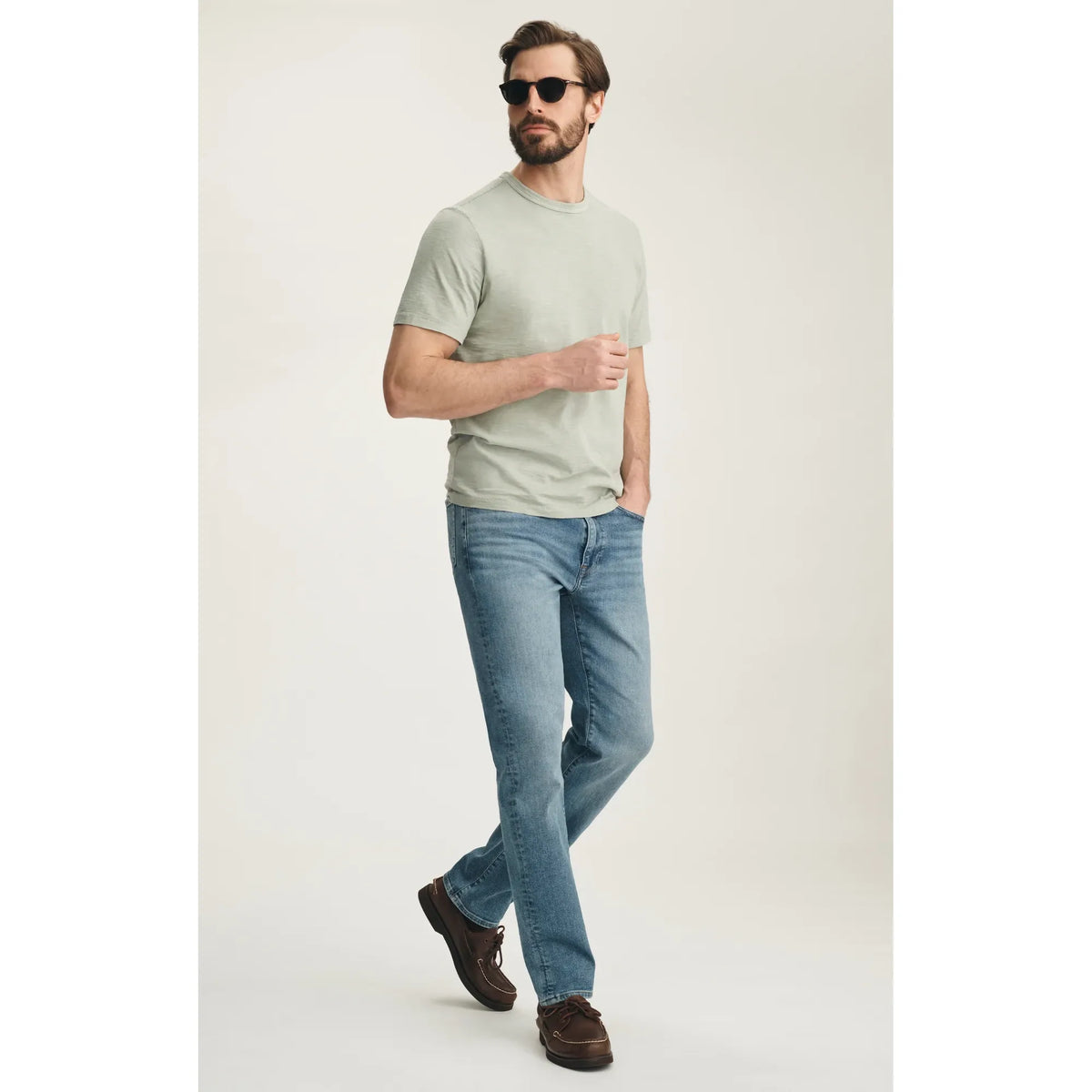 Male model wearing 34 Heritage Camino straight-leg jeans in Lt Brushed Vintage with light blue wash.