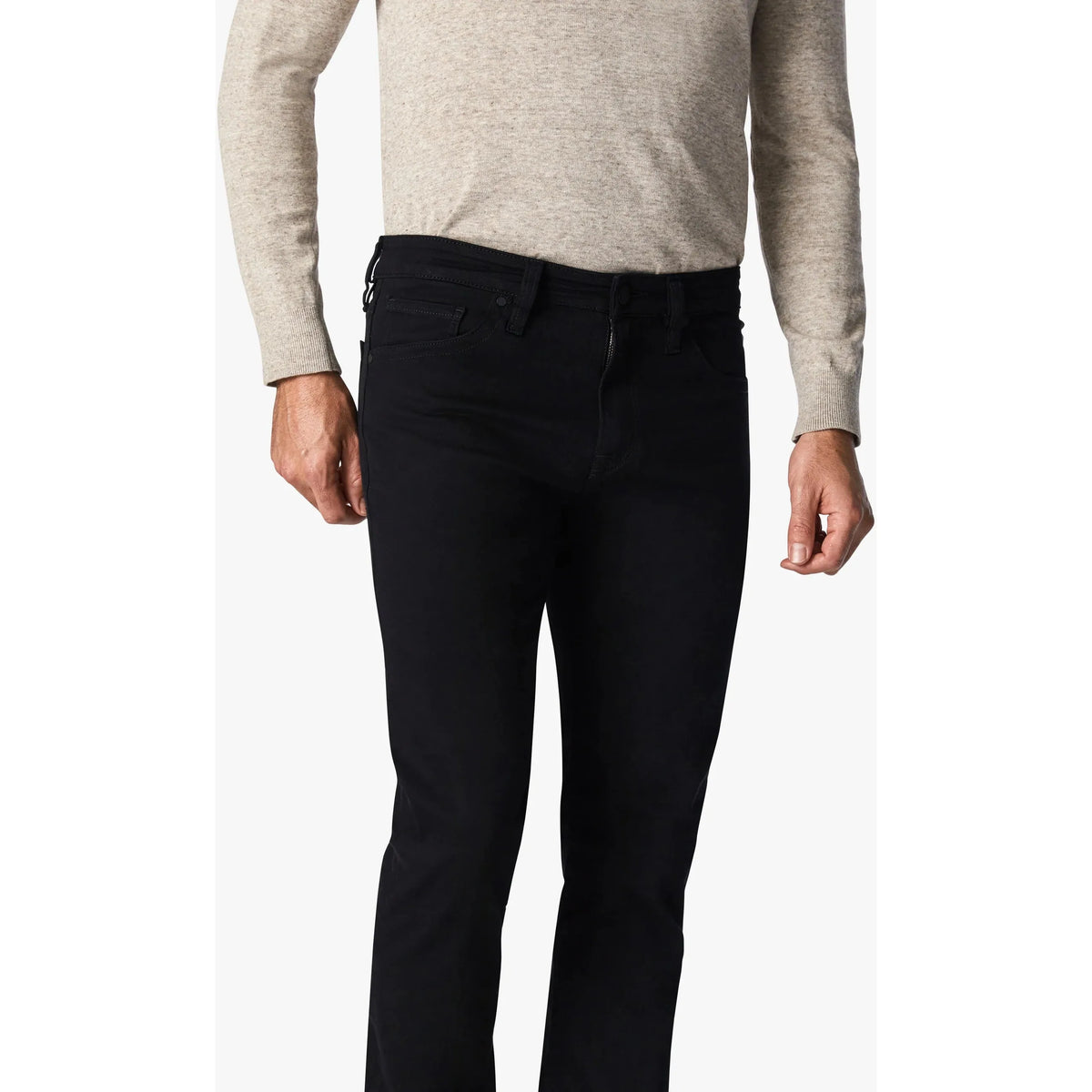 34 Heritage Courage Black Vintage Comfort jeans showcase a stylish fit, blending denim aesthetics with ultimate comfort.