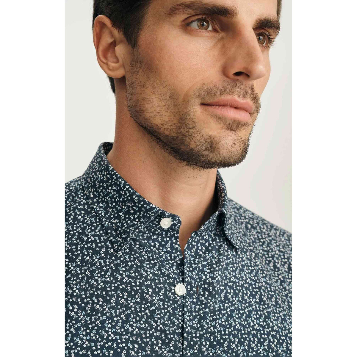 Man wearing 34 Heritage Flower Luxe Twill Shirt in vintage indigo with tiny floral print, short-sleeve button-up.