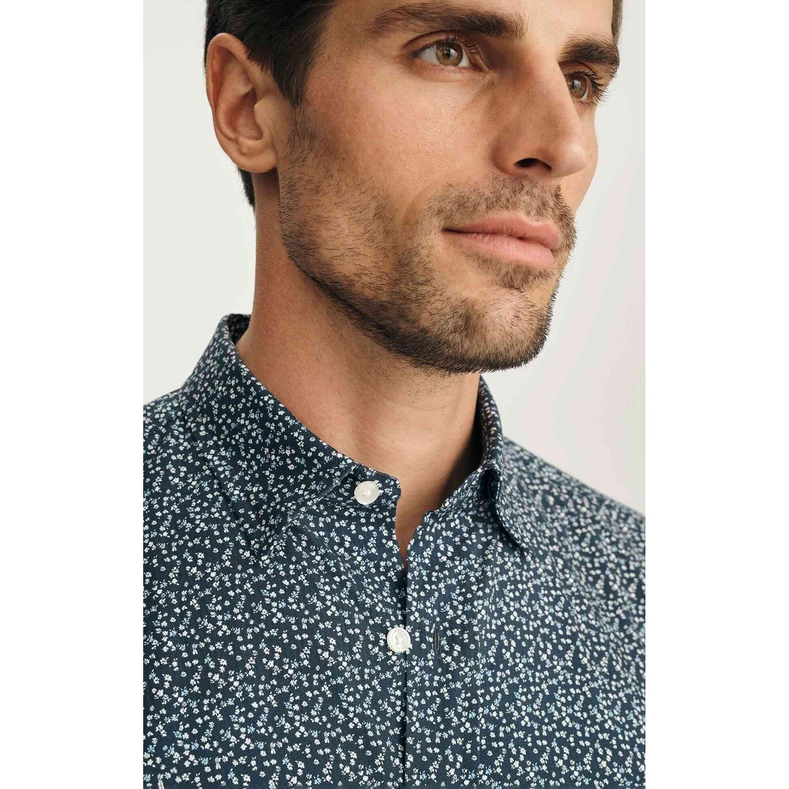 Man wearing 34 Heritage Flower Luxe Twill Shirt in vintage indigo with tiny floral print, short-sleeve button-up.