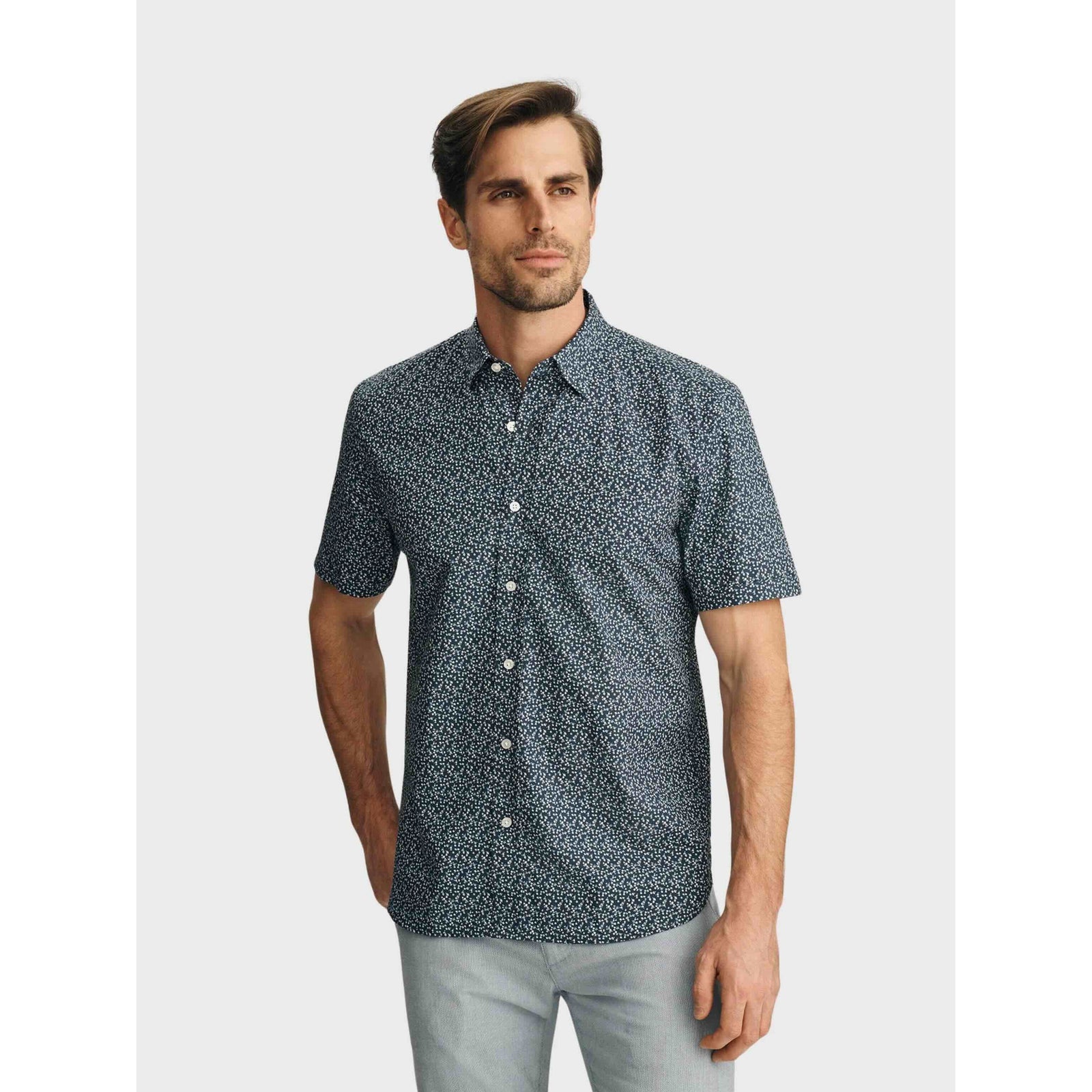 34 Heritage Flower Luxe Twill Shirt in vintage indigo with mini floral print, short-sleeve button-up worn by a man.