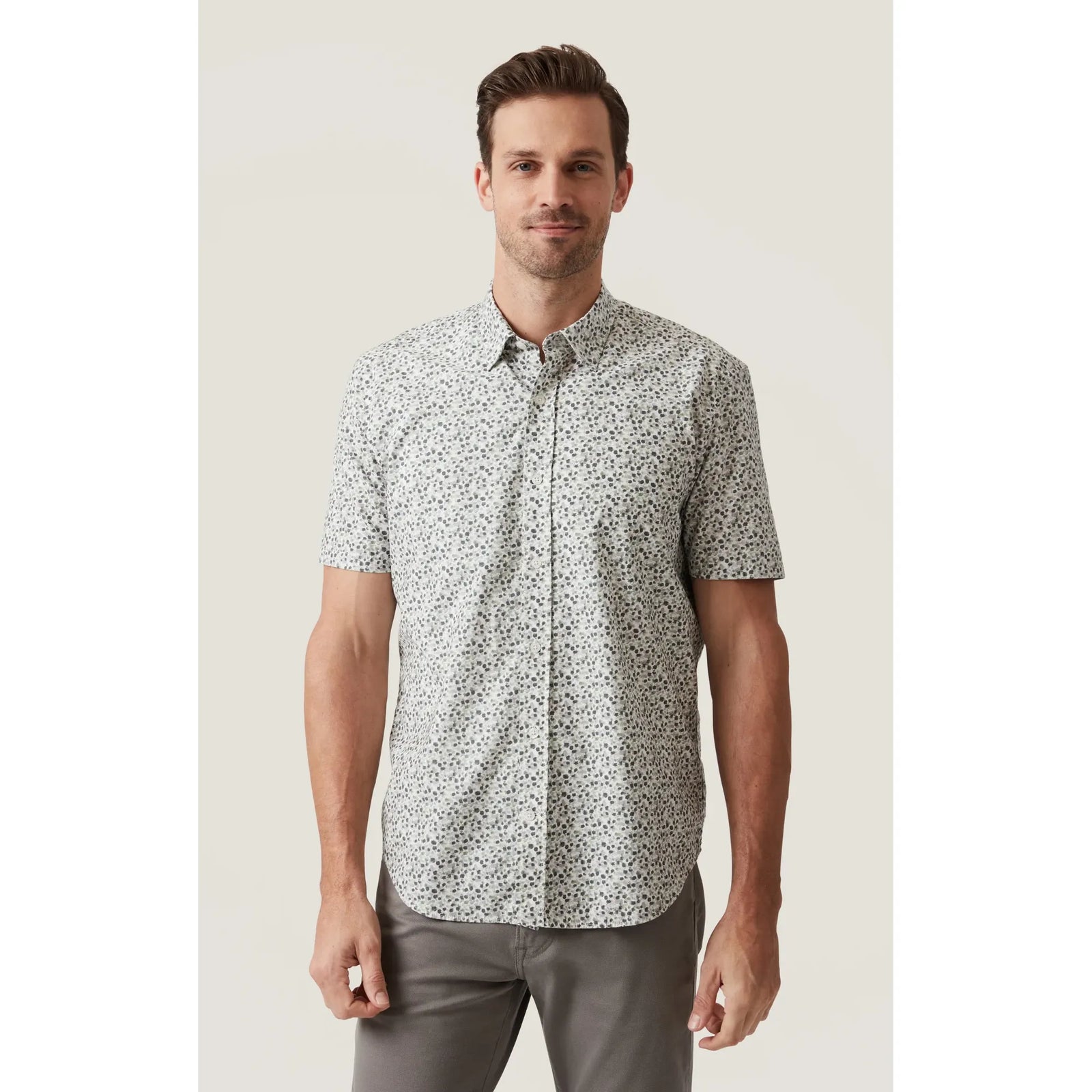 34 Heritage Grove Short Sleeve Shirt on a male model with a white floral pattern.