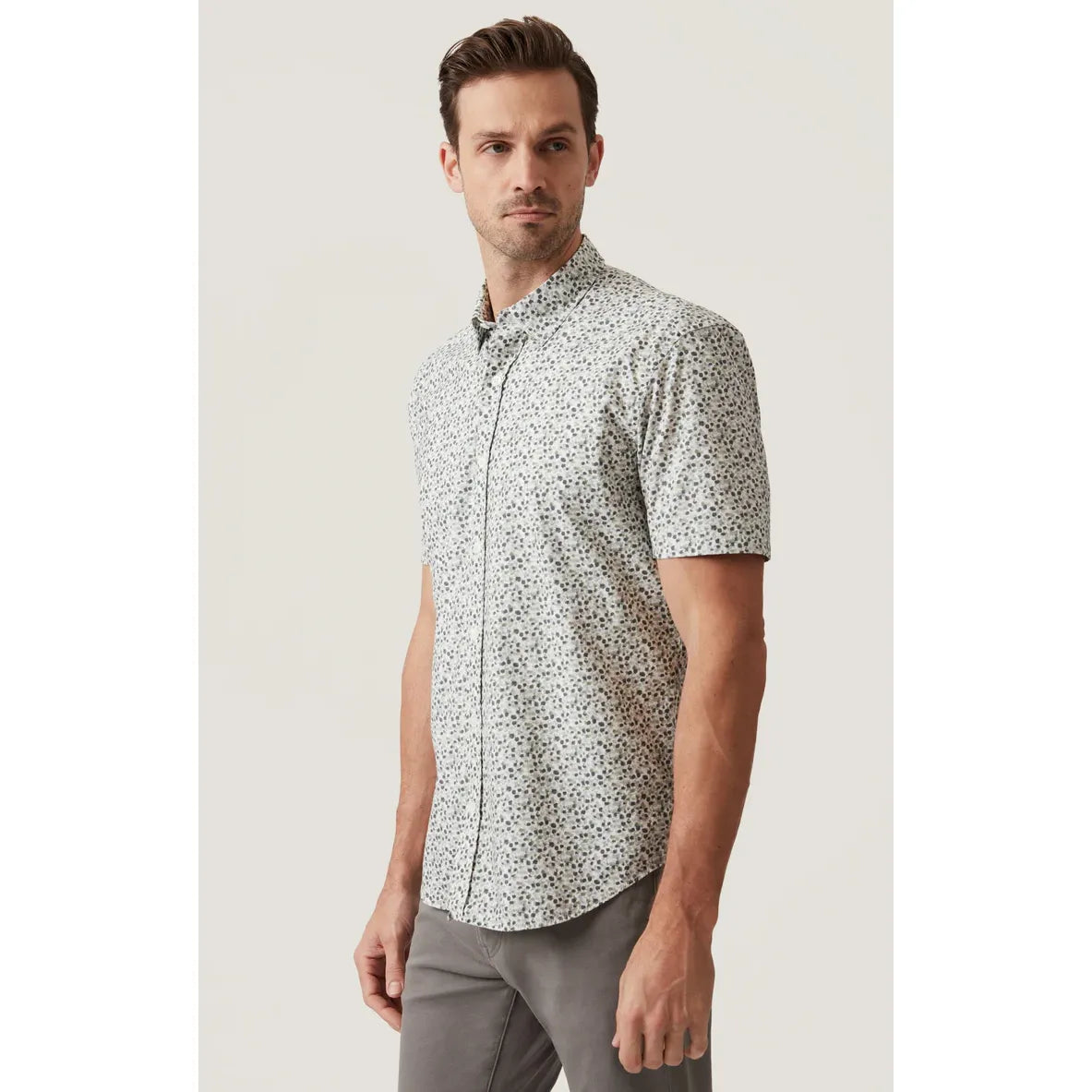 34 Heritage Grove Short Sleeve Shirt on a male model with a white floral pattern.