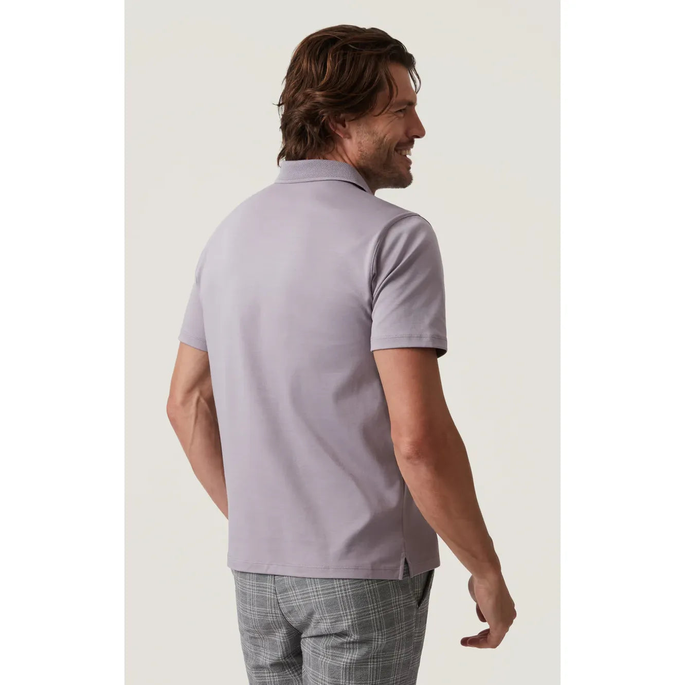 Man wearing 34 Heritage Polo Shirt in lavender with textured collar and three-button neckline; close-fit, breathable.