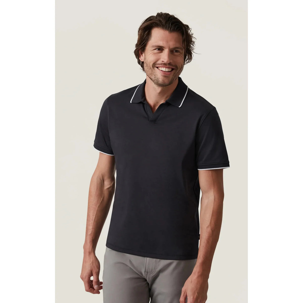 Stylish man models the 34 Heritage Riviera Polo, featuring white lining for a polished look perfect for any occasion.