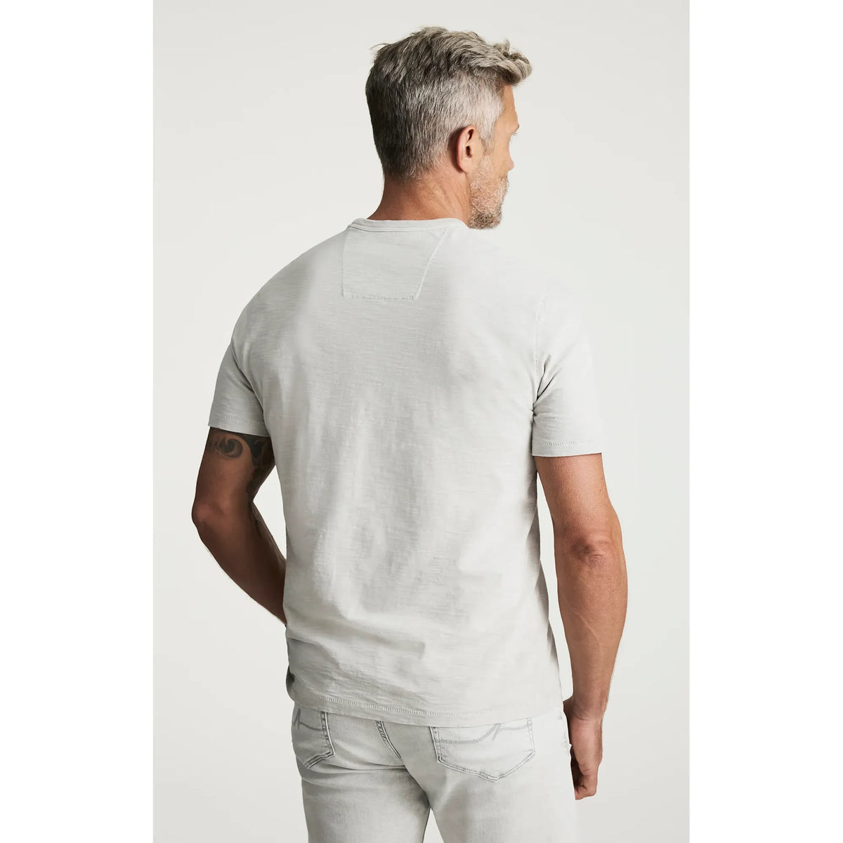 Back view of a man wearing a light gray 34 Heritage Slub Crew Tshirt, short sleeves.
