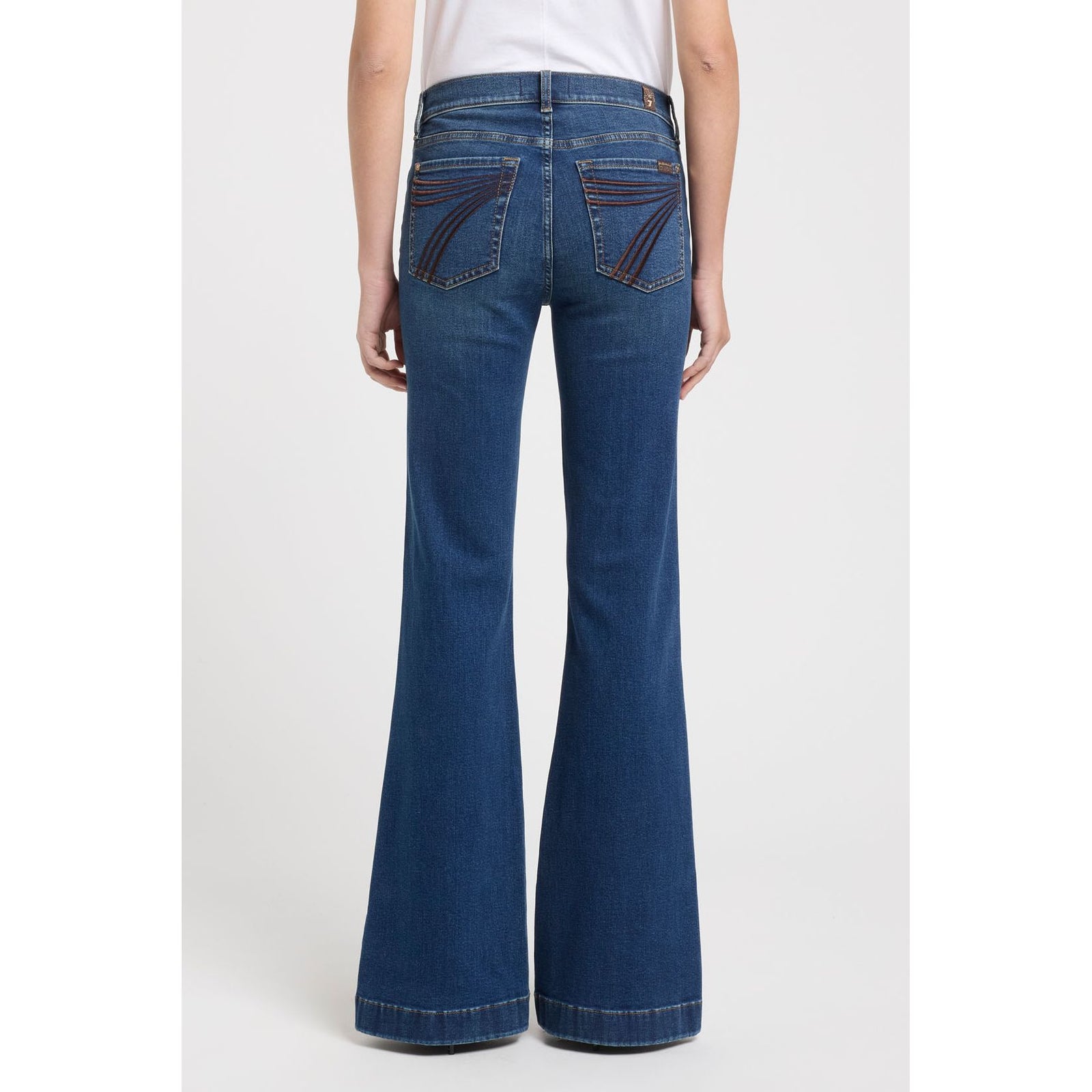 7 for all Mankind Dojo in Koko mid-rise flare jeans back view with arched brown embroidery on back pockets.