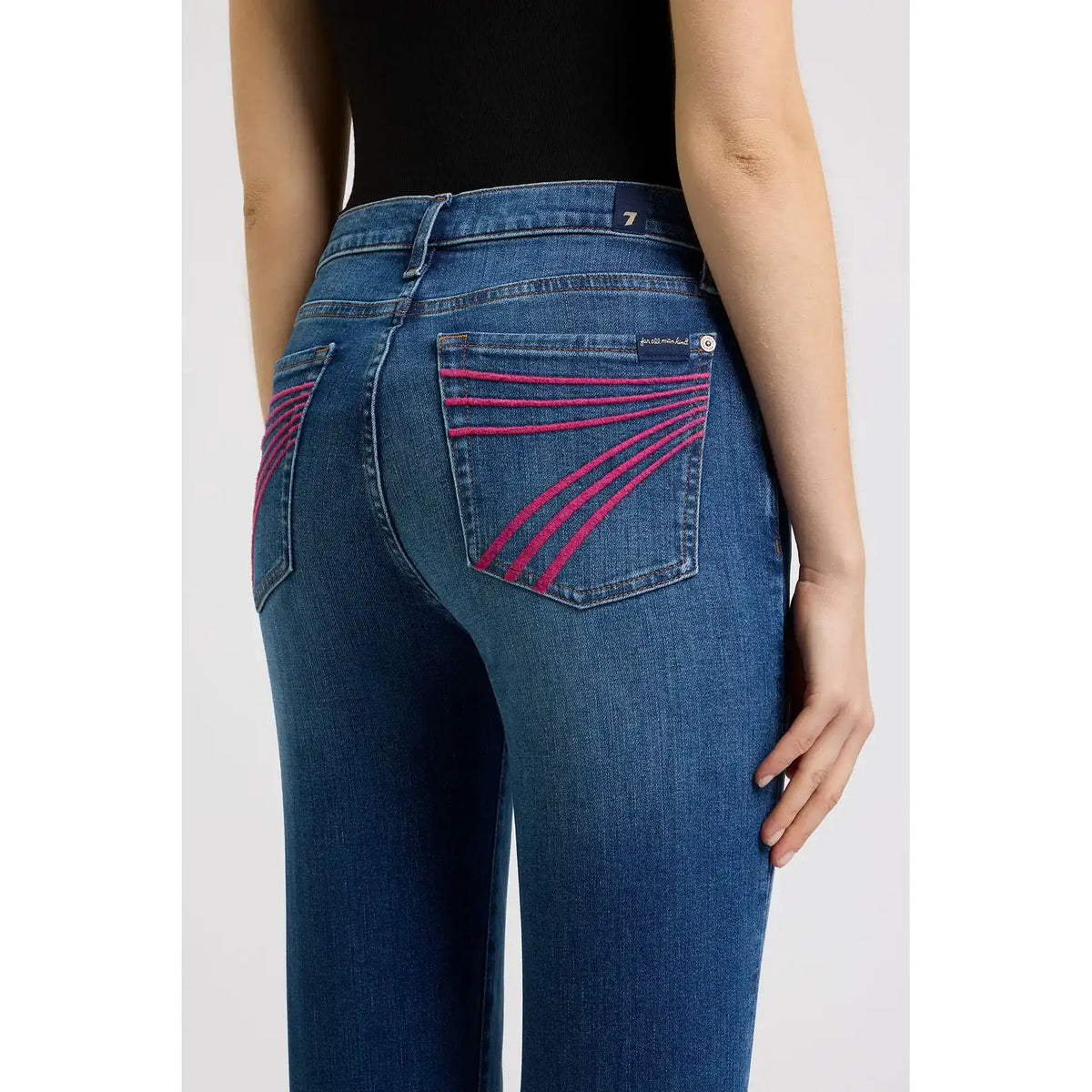 7 for all Mankind Dojo jeans in Moonwater, back view with pink stitched pocket lines and mid-rise flare.