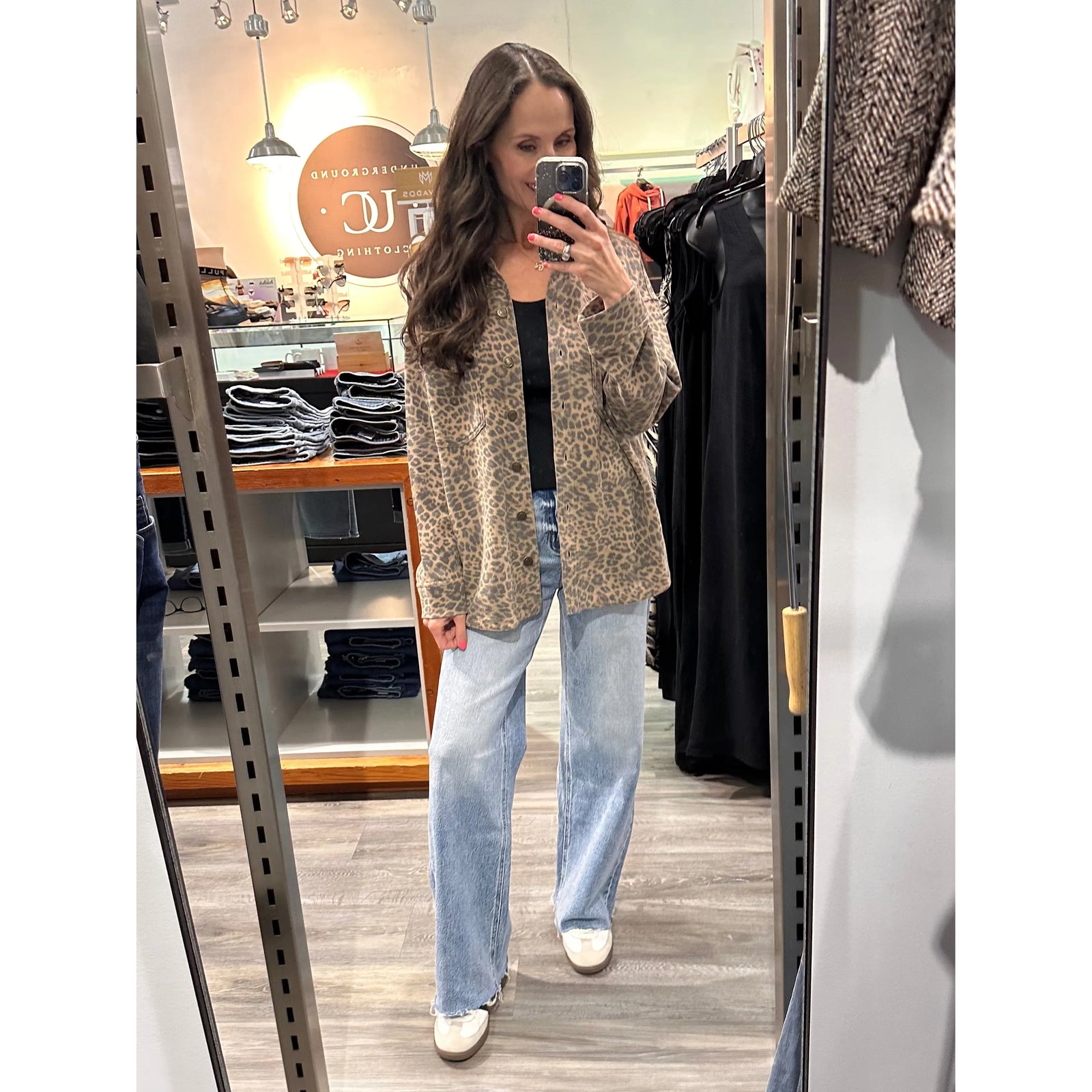 Woman modeling Z Supply All Day Knit Leopard Jacket with button front and leopard print in store mirror.