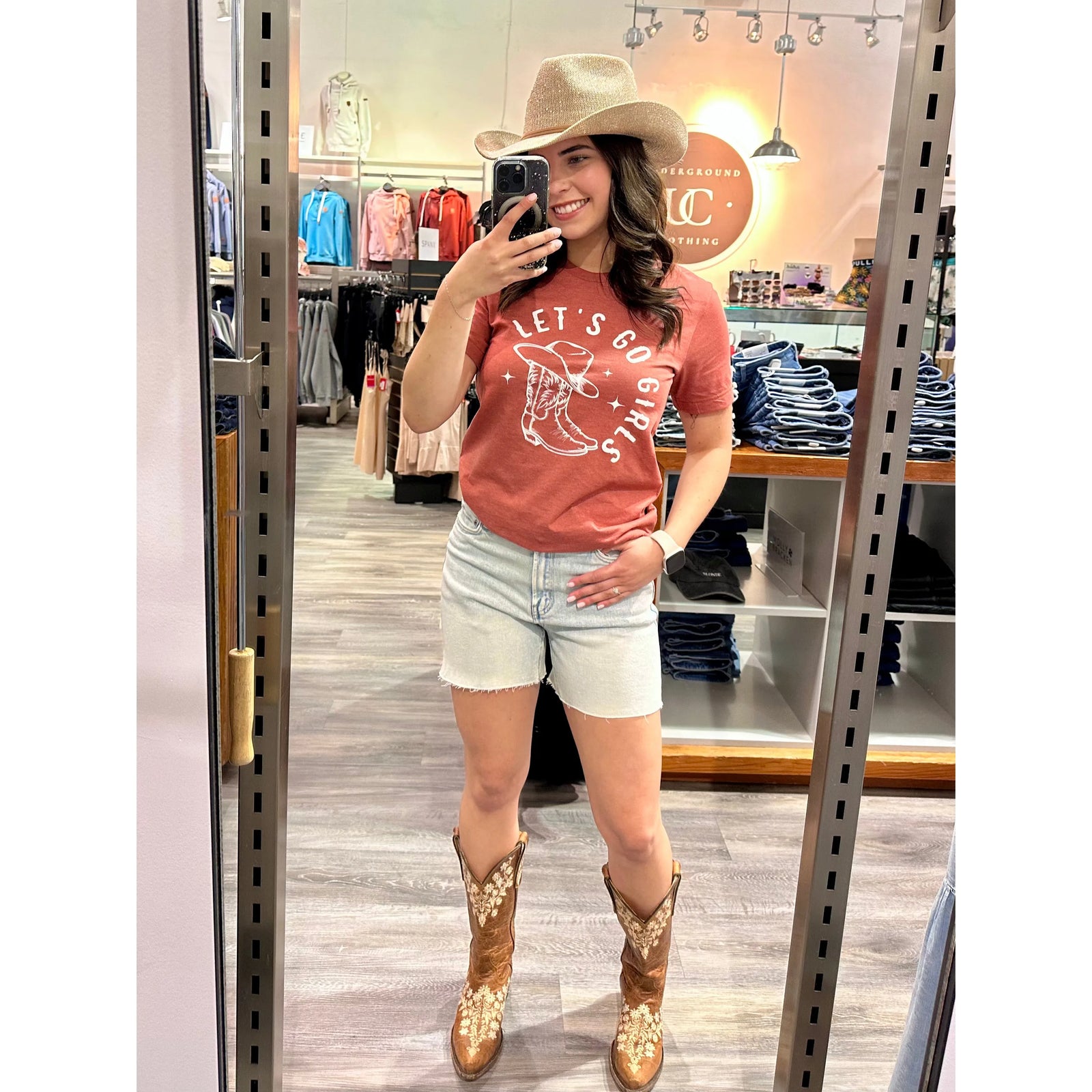 A woman in a relaxed tee showcasing "Let's Go Girls," perfect for a fun-loving, carefree vibe.