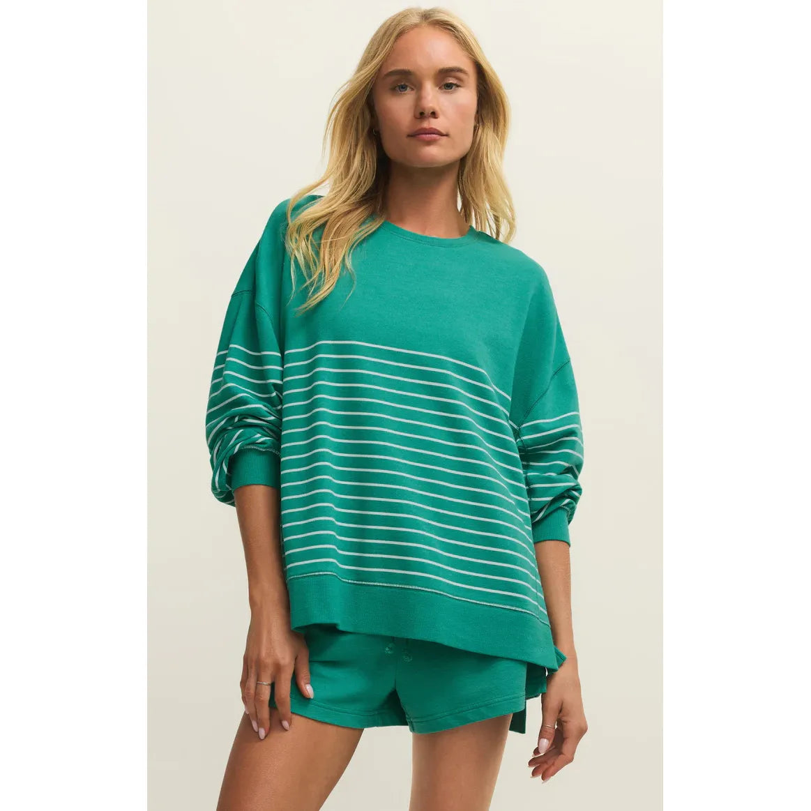 Model wearing teal striped Weekender Sweatshirt with matching teal shorts.