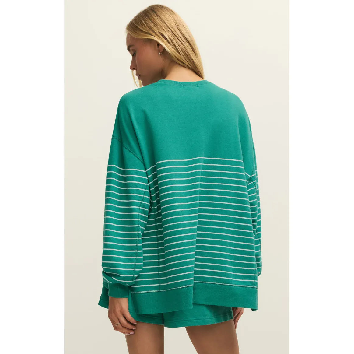 Model wearing teal striped Weekender Sweatshirt with matching teal shorts.
