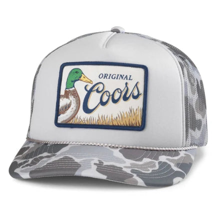 White trucker hat with grey camo brim featuring Coors Original patch with mallard duck graphic and script logo.